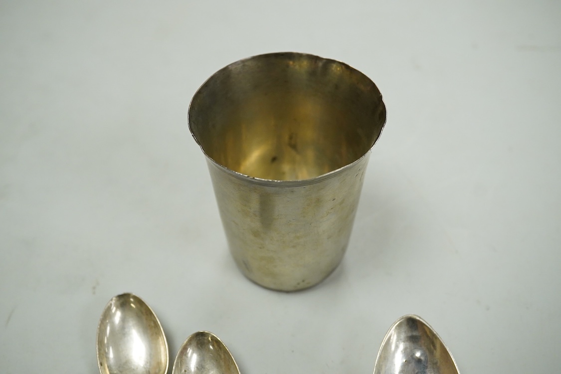 A continental white metal beaker, 69mm, five late Victorian silver coffee spoons, a silver pusher and butter knife and three white metal items.